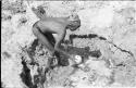 "/Gao Music" dipping ostrich eggshell at a waterhole