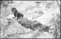 Lorna Marshall and Elizabeth Marshall Thomas lying on the ground resting