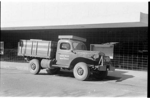 Truck in town, with sign painted on side reading "Peabody Museum of Harvard University"