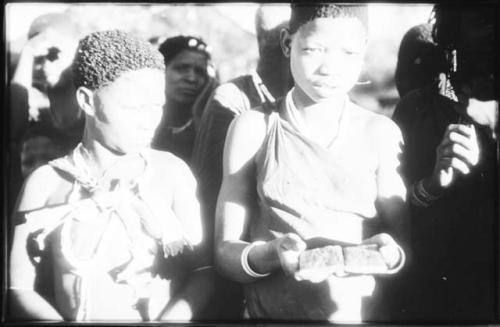 Two women, one holding clappers (copy of slide 2001.29.7035)