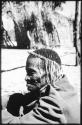 Medicine man holding a rattle and sitting with a group of people (copy of slide 2001.29.7063)