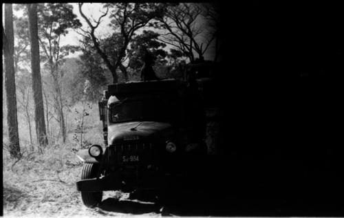 Expedition truck, with trees in background (part of image obscured)