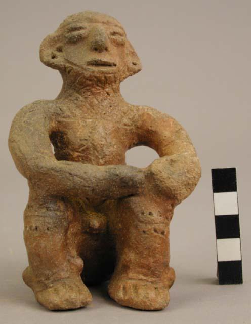 "Sukia-like" seated figure with Barriles type headdress; body incised