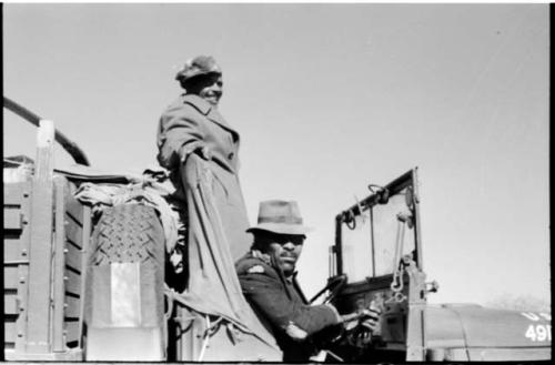 Wilhelm Camm sitting and Heinrich Neumann standing behind him in an expedition truck