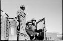 Heinrich Neumann standing, and Wilhelm Camm and Casper Kruger sitting inside an expedition truck