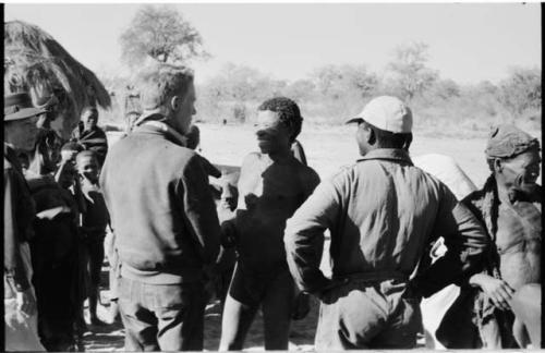 "Old Gau," father of //Kushay and !Ungka, being greeted by Kernel Ledimo and John Marshall