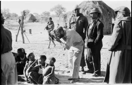 Group of people sitting, with Daniel Blitz taking a photograph