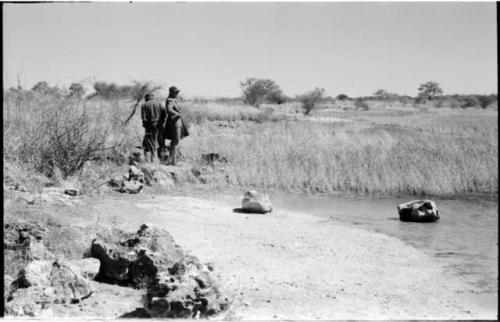 Casper Kruger and another expedition member standing and looking at the water