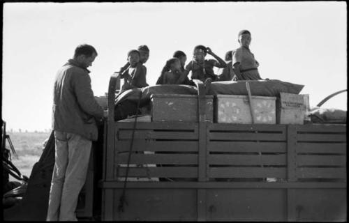 Group of people standing on top of the expedition truck with William Donnellan next to them