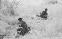 //Kushay and another woman digging, crouched in the grass