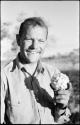 William Donnellan holding a cucumber