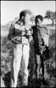 "Gao Medicine" standing and talking with William Donnellan who is holding a cucumber