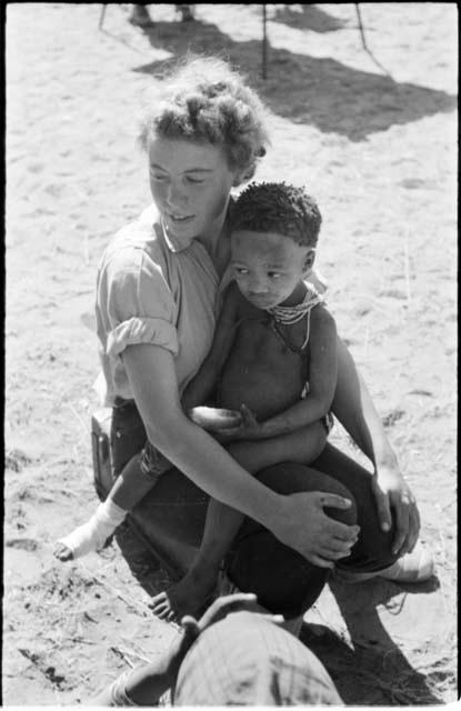 Norna, with bandaged foot, being held by Elizabeth Marshall Thomas