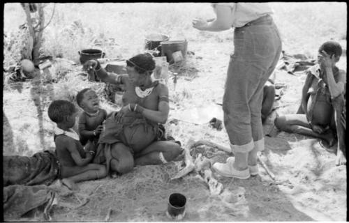 Di!ai sitting with her two youngest children, /Gaishay (left) and Debe (right), and Elizabeth Marshall Thomas' legs