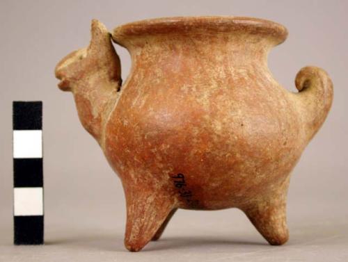 Zoomorphic tripod jar. Light reddish slip with vertical red lines.  Animal (camel family such as llama?)