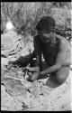 Oukwane scraping sansevieria fibers to make a cord