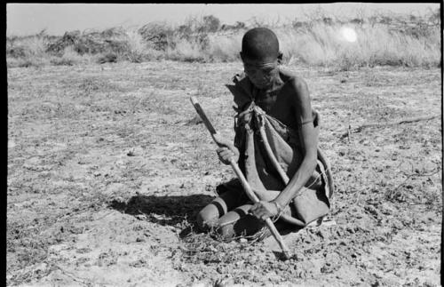 /Twikwe clearing ground with a digging stick