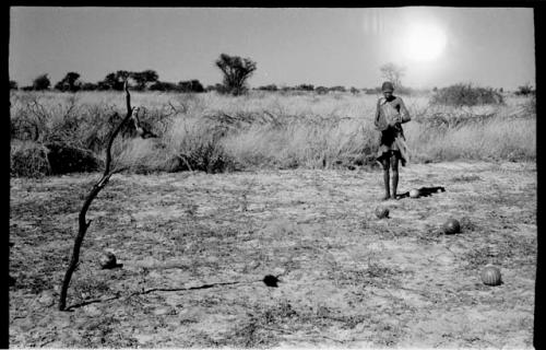 /Twikwe in a clearing holding a pan