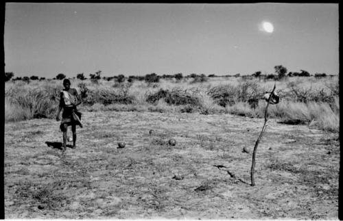 /Twikwe in a clearing holding a pan