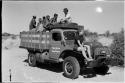 Oukwane, /Twikwe, /Gaiamakwe, Kernel Ledimo, Lorna Marshall, and another person on top of expedition truck, Elizabeth Marshall Thomas on fender