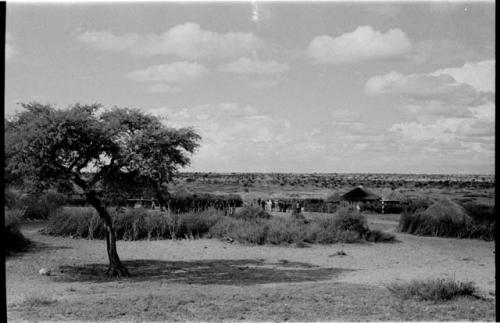 Group of people standing in a kraal, distant view