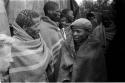 Gishay talking to one of the men from Lutlhe, people standing in the background