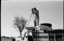 Daniel Blitz with movie camera on top of expedition truck