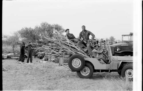 Casper Kruger, Simon Molamo, and another expedition member in a Jeep full of wood