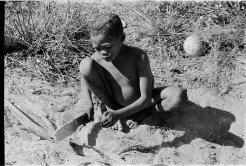 /Gaiamakwe cooking meat in the ashes using a fire paddle