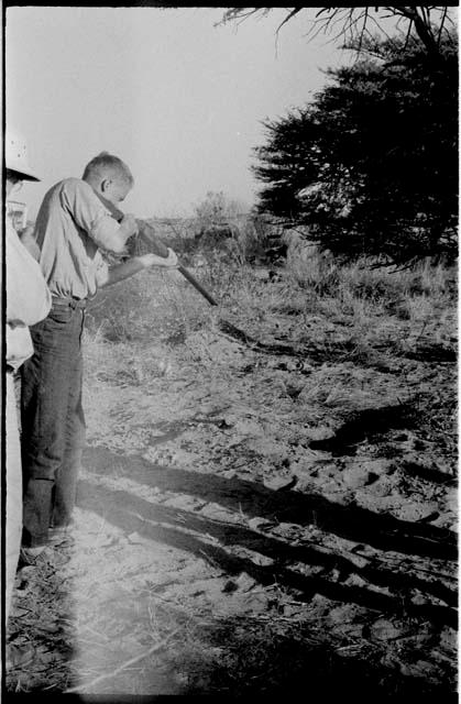 John Marshall pointing a shot gun at the mamba hole