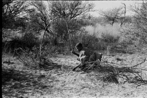 !Gai kneeling, setting a snare