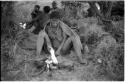 Elderly woman sitting by her fire