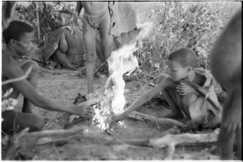 Family from "visiting group" sitting by their fire