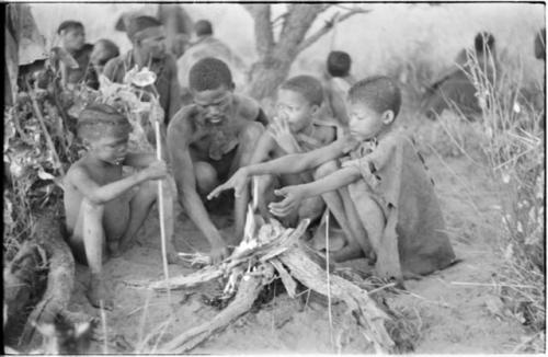 Group of visitors sitting around their fire