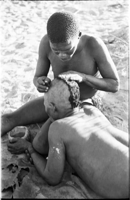!Gai seated, cutting another man's hair