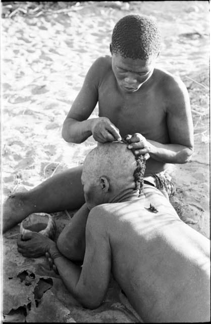 !Gai seated, cutting another man's hair