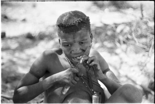 Tsekue cutting off a bite of meat