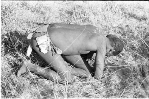 Boys tussling in grass