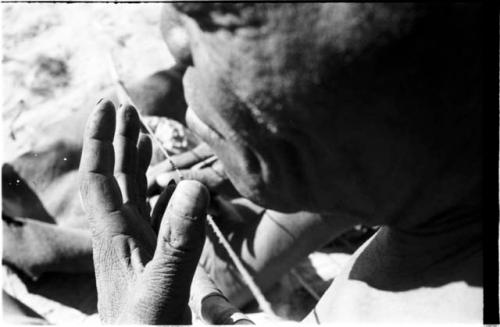 Close-up of Oukwane's hands showing playing a bow