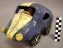 Ceramic polychrome car with driver figurine