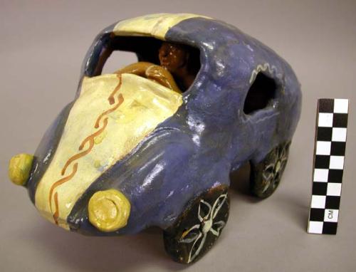 Ceramic polychrome car with driver figurine