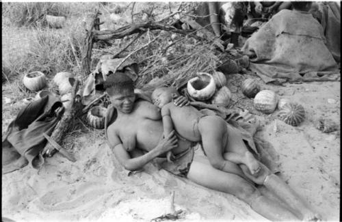 Visiting woman lying in her place in her werft with her child lying on her asleep