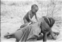 N!whakwe playing with visiting children