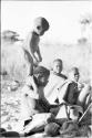 N!whakwe standing on his mother Tsekue's shoulders