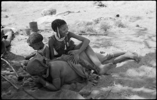 "The visiting girl" sitting with her leg thrown over !U who is lying down, and Norna sitting near them