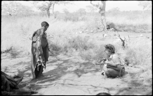 /Naoka imitating a medicine man, and Elizabeth Marshall Thomas sitting near her and laughing