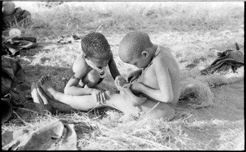 Di!ai's son /Gaishay and !U's son /Gaishay playing with a shoe