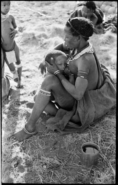 Di!ai sitting and nursing Debe with a tear on his cheek, and Norna leaning against her mother