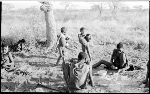 Two people cracking tsi, and two children standing