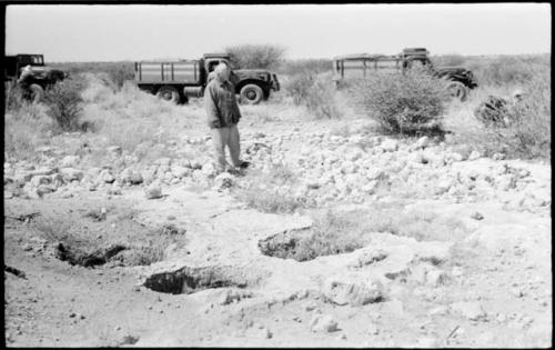 Laurence Marshall standing next to pits and expedition trucks